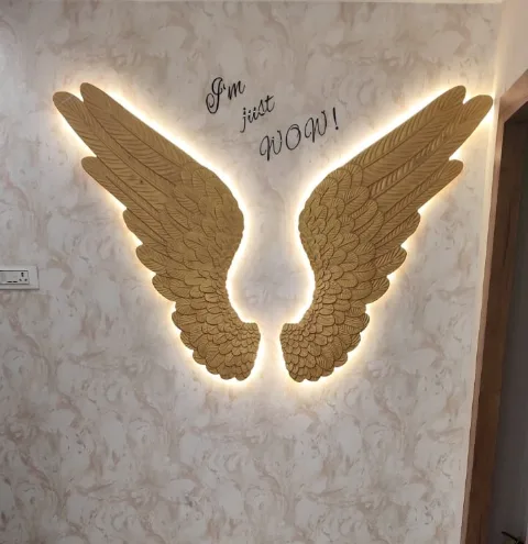 Illuminated gold wings artwork with the words ‘I’m just WOW!’ on a marble-effect wall